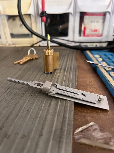 Locksmith rekeying a residential door lock cylinder
