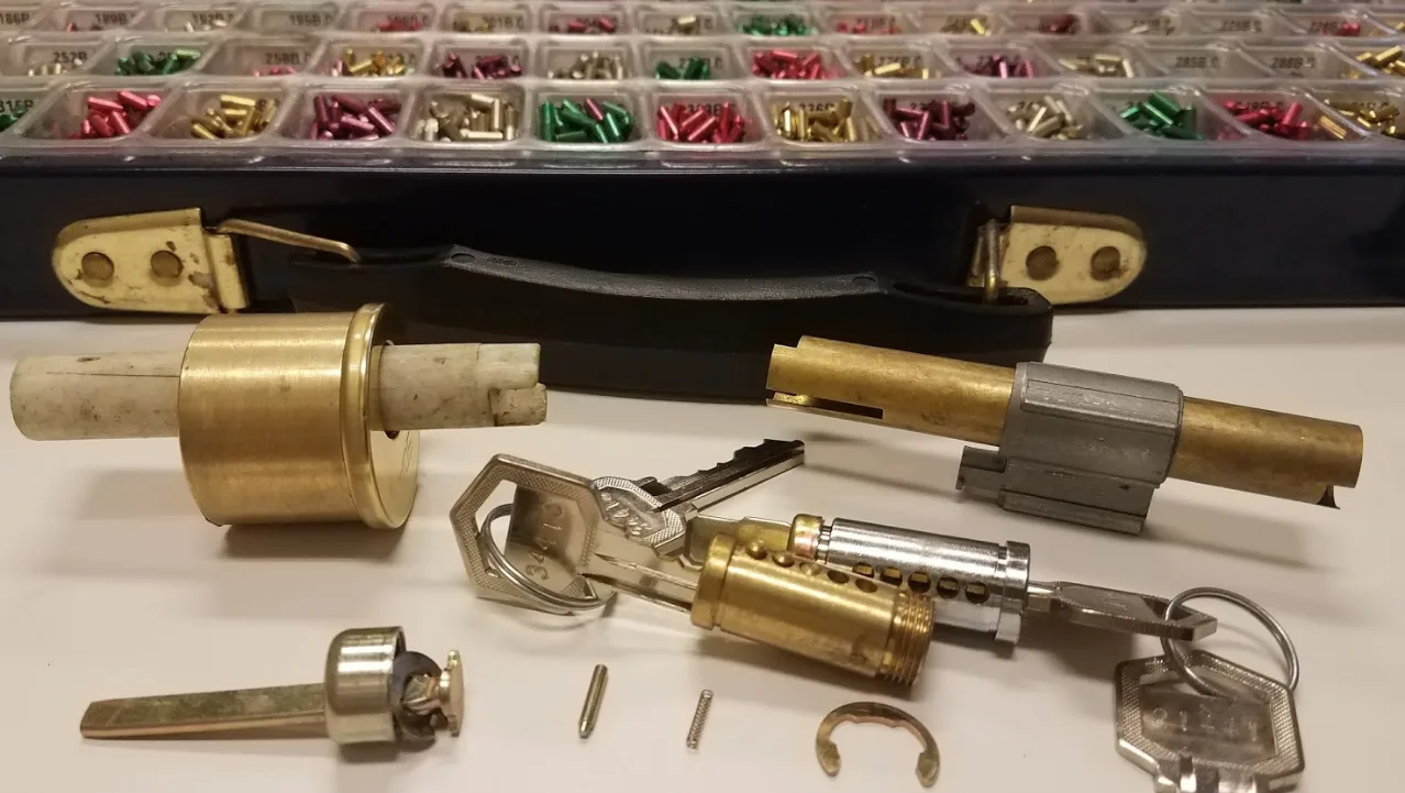 Locksmith rekeying a residential door lock cylinder in Grant-Valkaria, FL