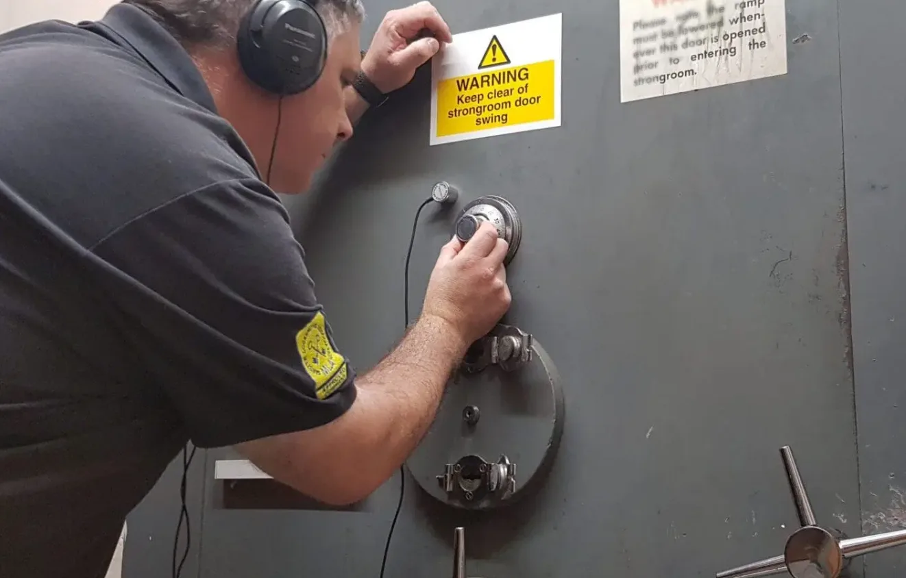Locksmith working on a commercial safe combination lock in Titusville, FL