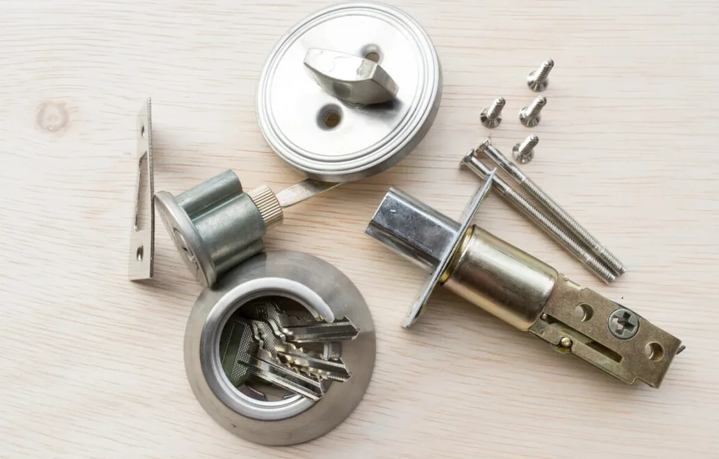 Technician measuring door opening force with calibrated push-pull force gauge showing 5 pound reading
