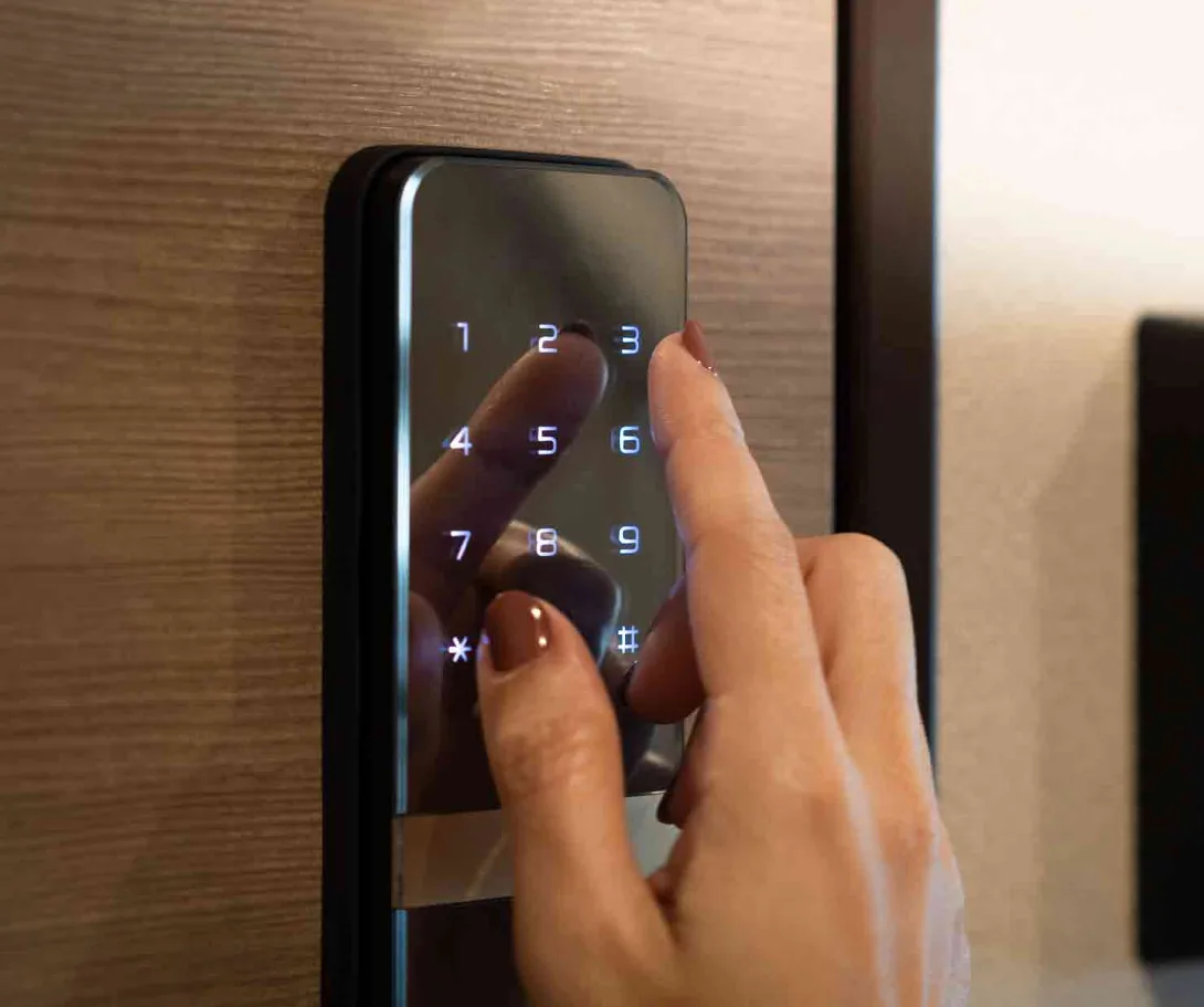 Smartphone showing smart lock app with guest access codes being managed for Airbnb vacation rental property