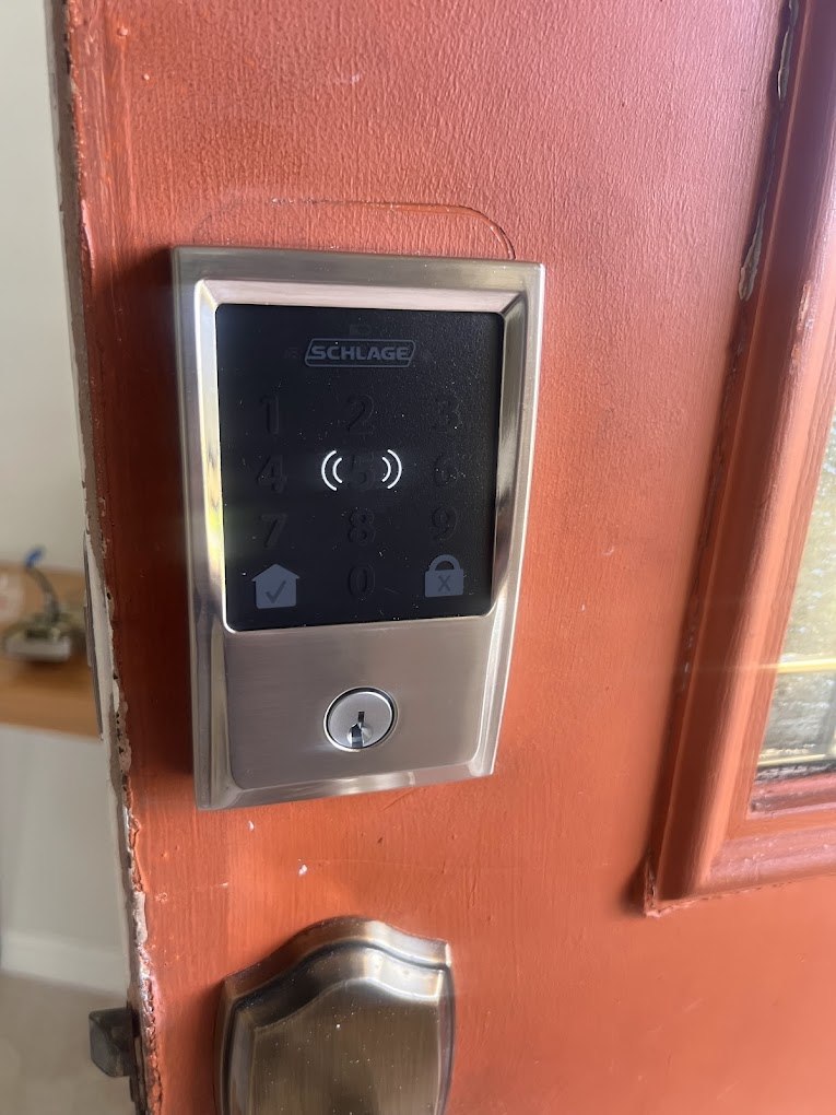 Schlage Encode Plus smart lock installed on Airbnb vacation rental door showing keypad for guest code entry