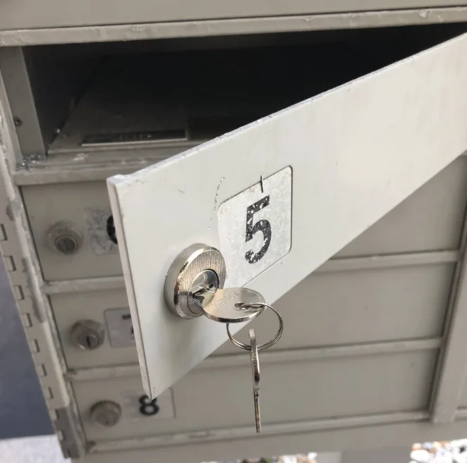 Licensed locksmith replacing a mailbox lock